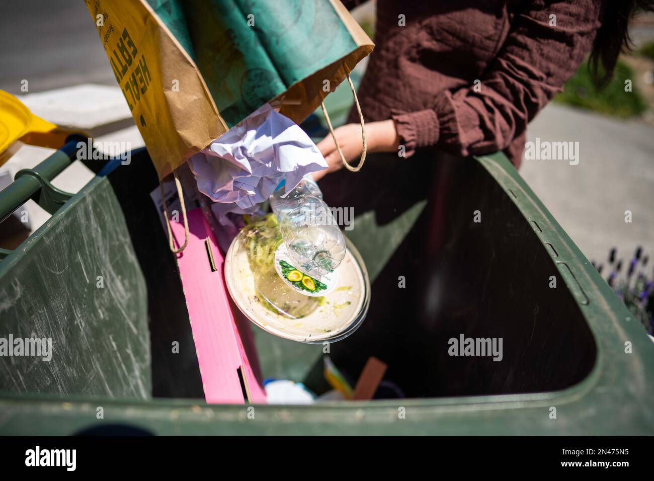 sorting recycling and rubbish in bins in hobart tasmania australia in
