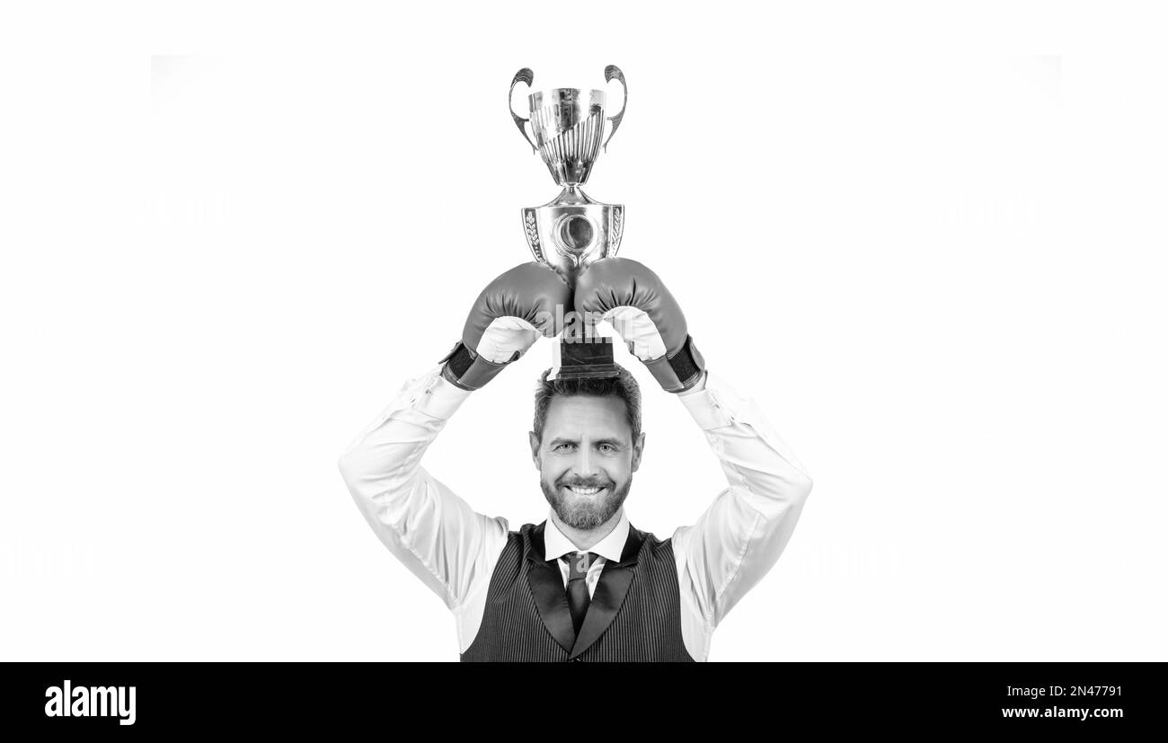 happy guy in boxing gloves and formalwear hold champion cup isolated on