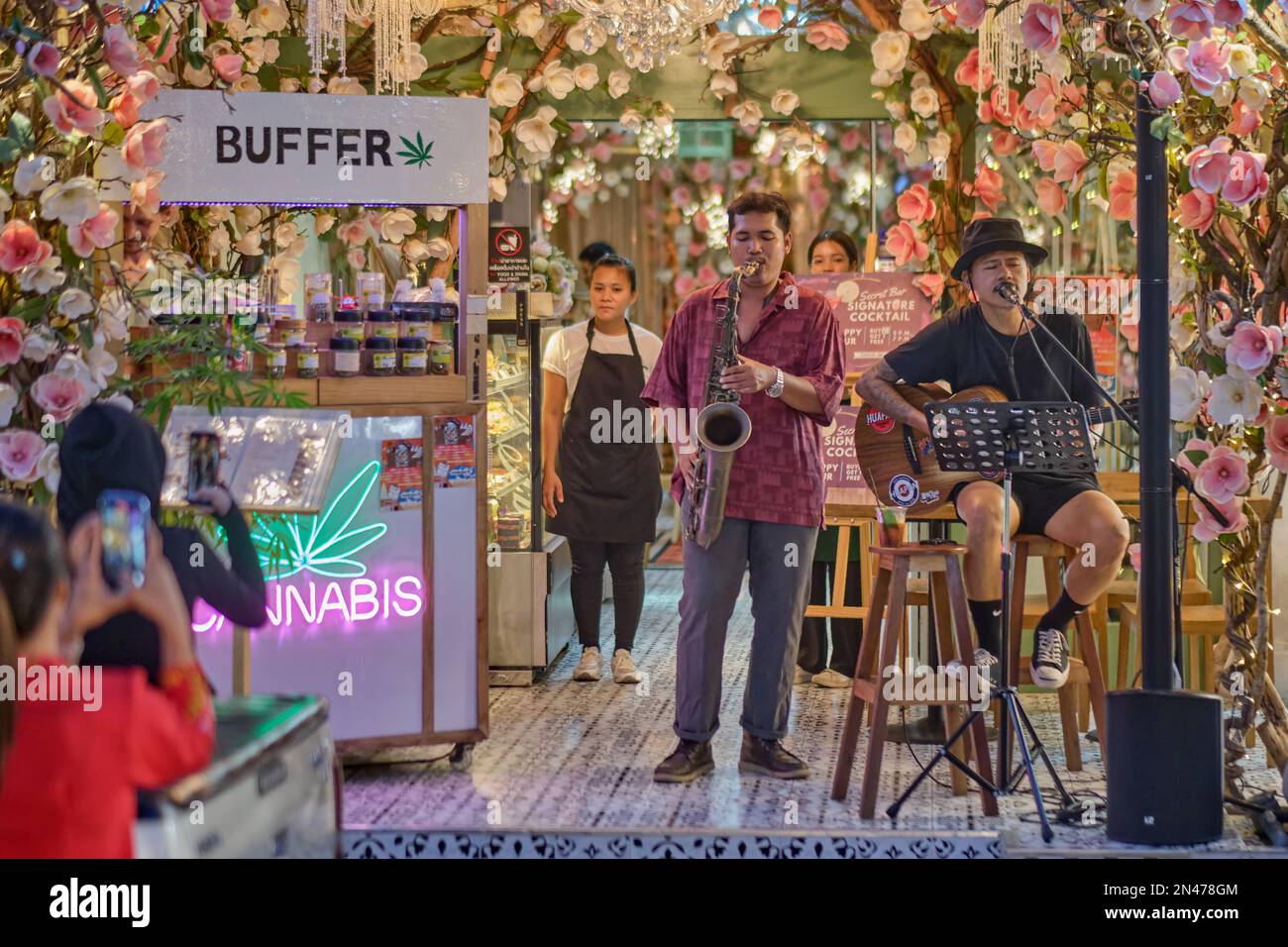 a-two-man-band-plays-outside-a-newly-opened-cannabis-shop-in-thalang