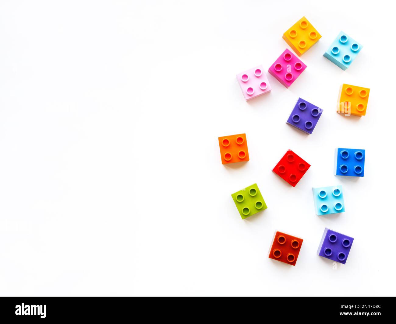 Colorful constructor blocks. Toy bricks without order. Place for text ...