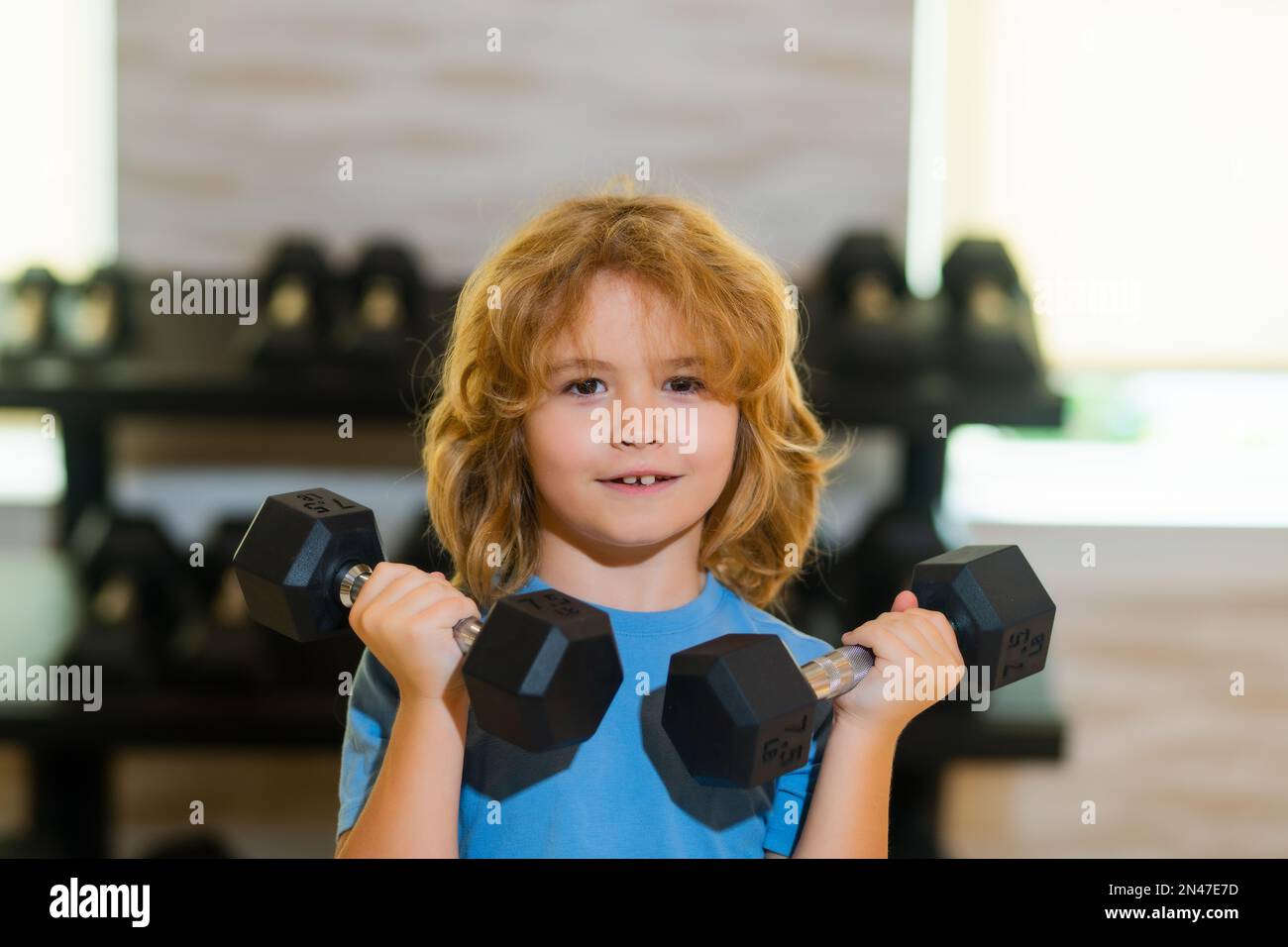 Child workout. Kid sport. Child exercising with dumbbells. Sporty child ...