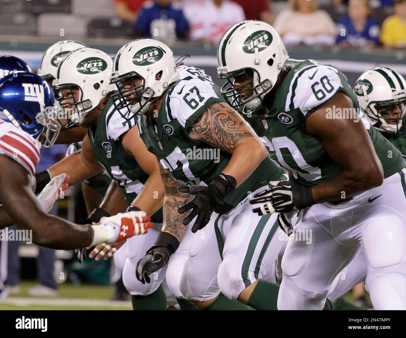 New York Jets Nick Mangold (74), Brian Winters (67), and D'Brickashaw ...