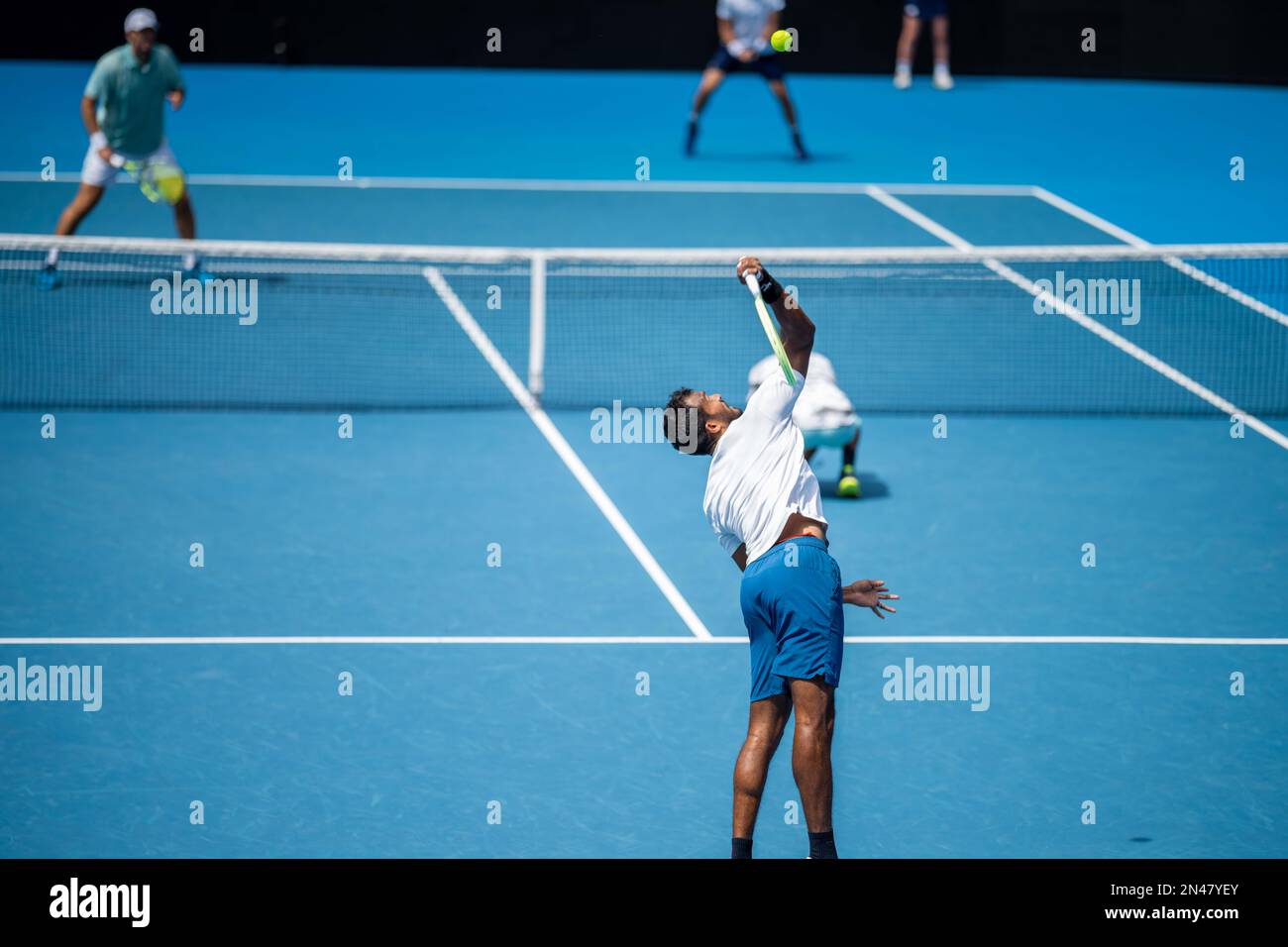 Tennis player serving in a tennis match, with leg drive in a game of sport Stock Photo Alamy