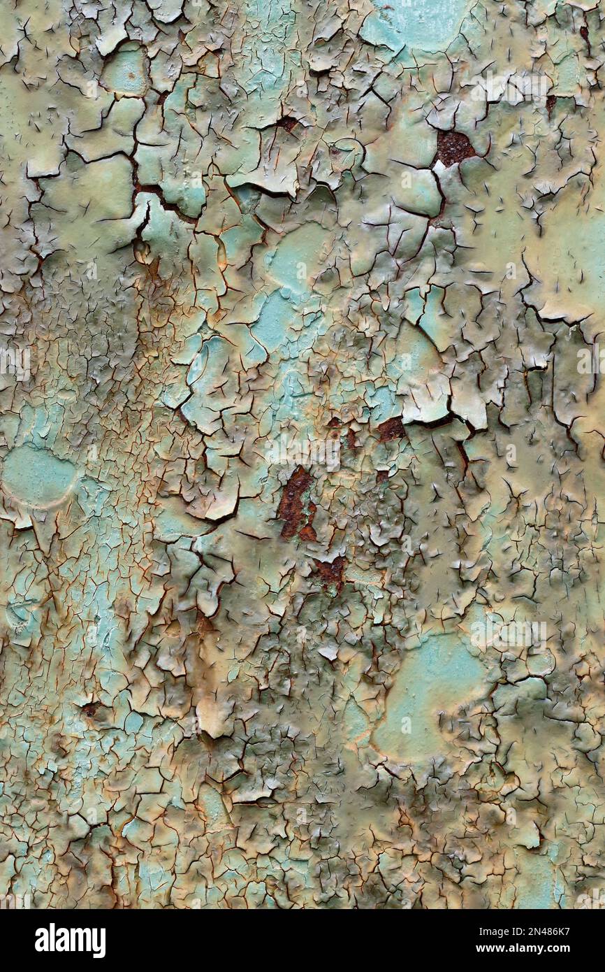 Detail of the cracked and peeled paint on the rusty iron surface Stock Photo