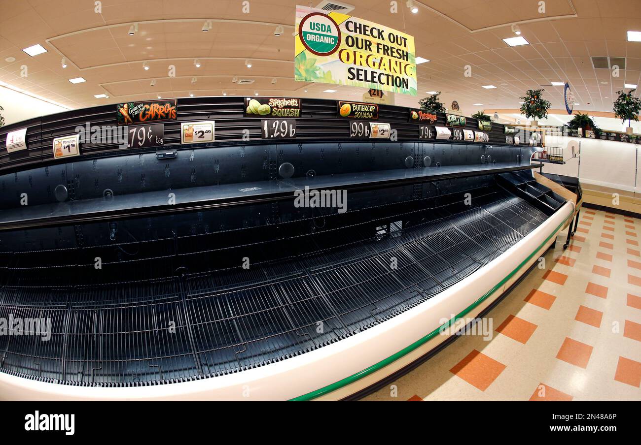 In this photo made with a fisheye lens, a sign sits atop empty produce
