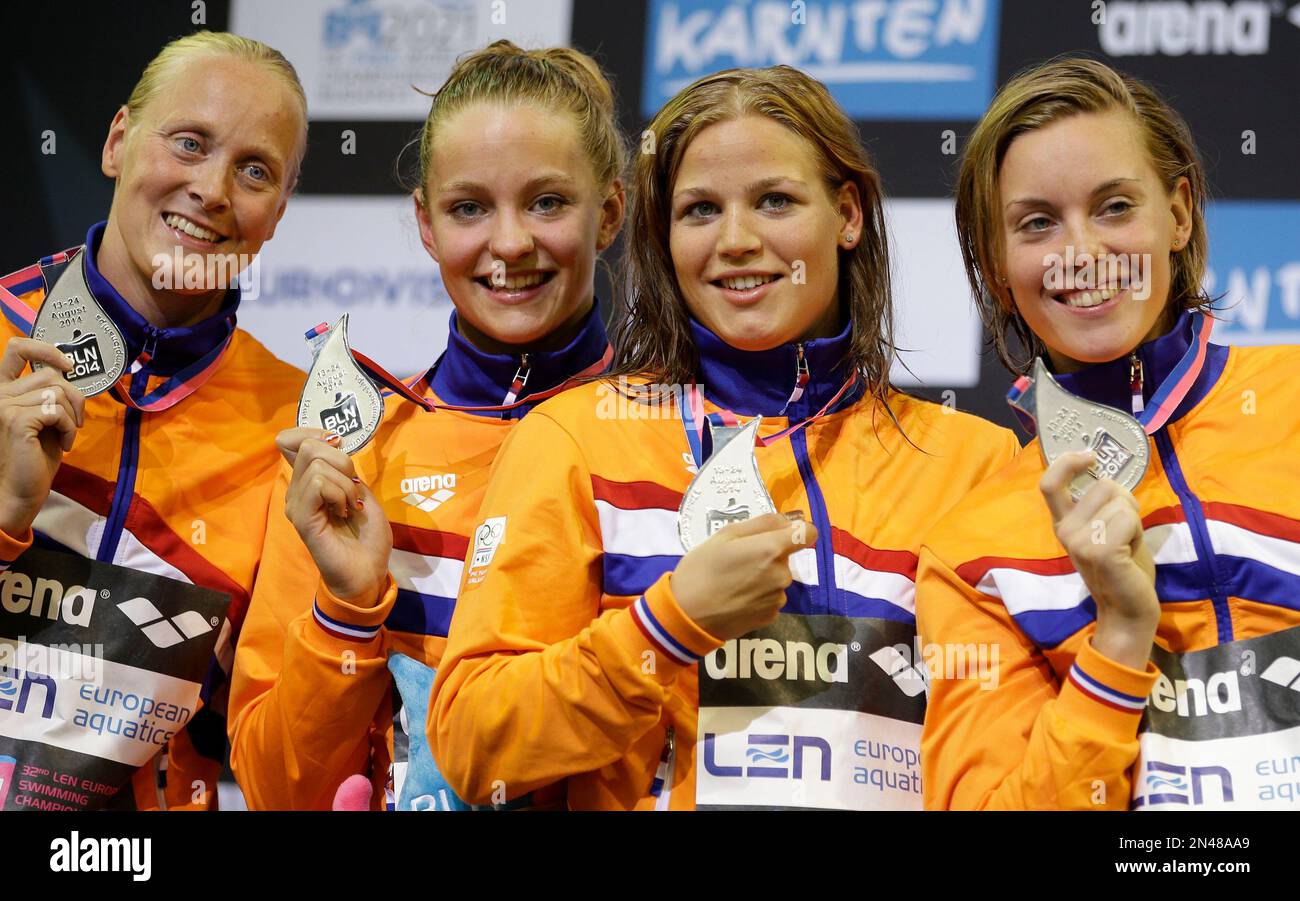 The Dutch relay team show their silver medals during the ceremony for