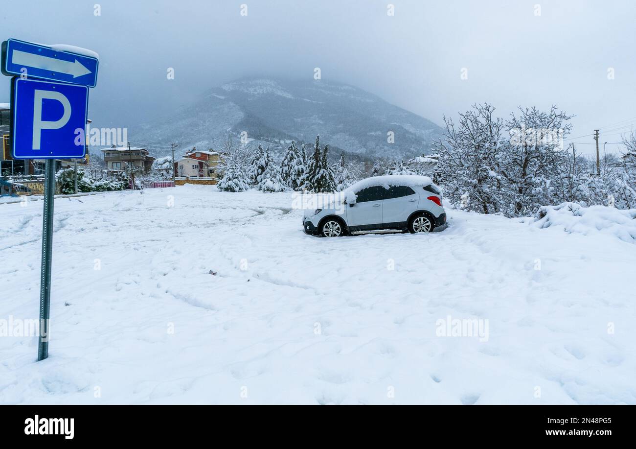 Winter time season snow ice nature parking lot sign car stuck. Vehicle suv waiting snow at the parking area icy road. High quality full hd photo. Stock Photo
