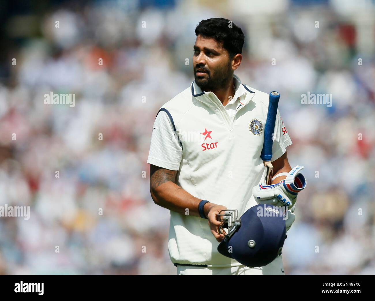 Indias Murali Vijay looks at a large video screen to see how he lost his wicket, caught out by Englands Joe Root off the bowling of Chris Woakes, during the first day