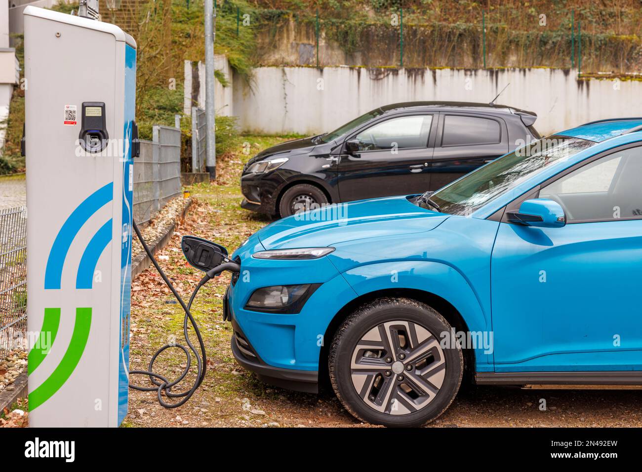 Electric car at a charging station Stock Photo Alamy