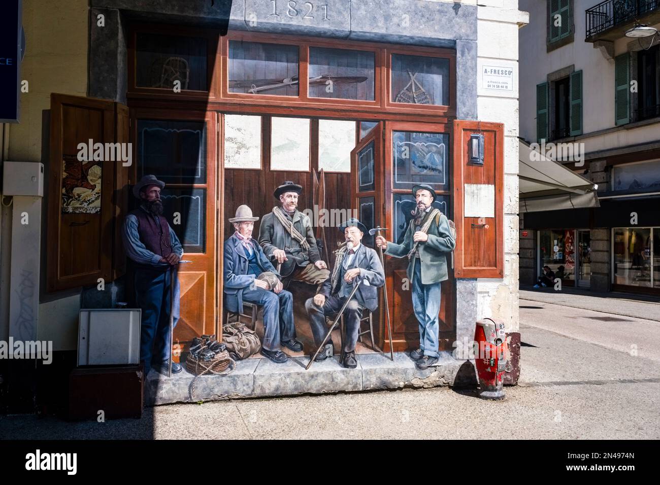 Artful grafitti about mountain guides in a shopping street in the center of Chamonix. Stock Photo