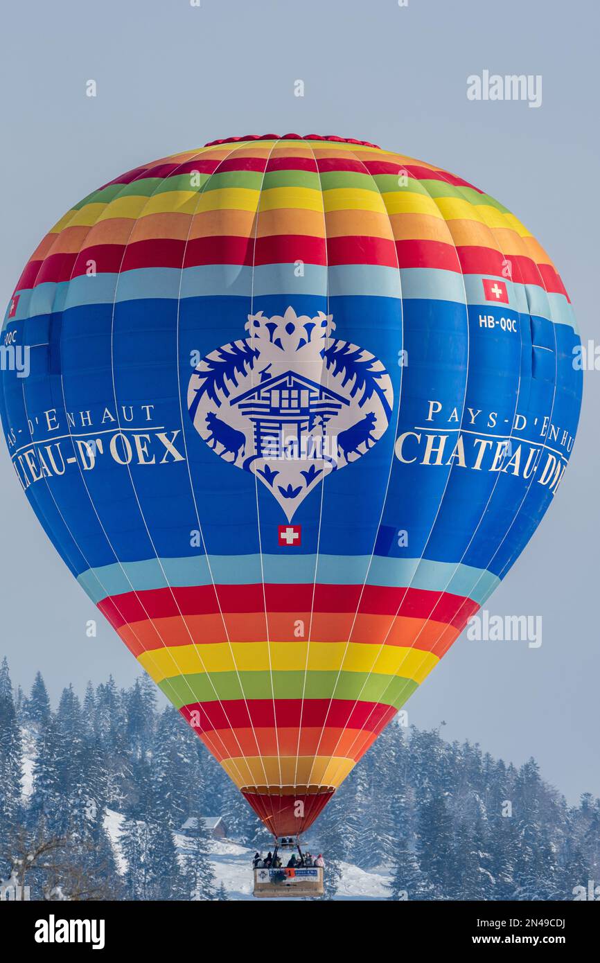 Chateau-d'Oex,Vaud, Switzerland - 23 January 2023: Hot Air Balloon flying in the sky. Hot air ballooning with mention pays d'enhaut. Balloon festival. Stock Photo