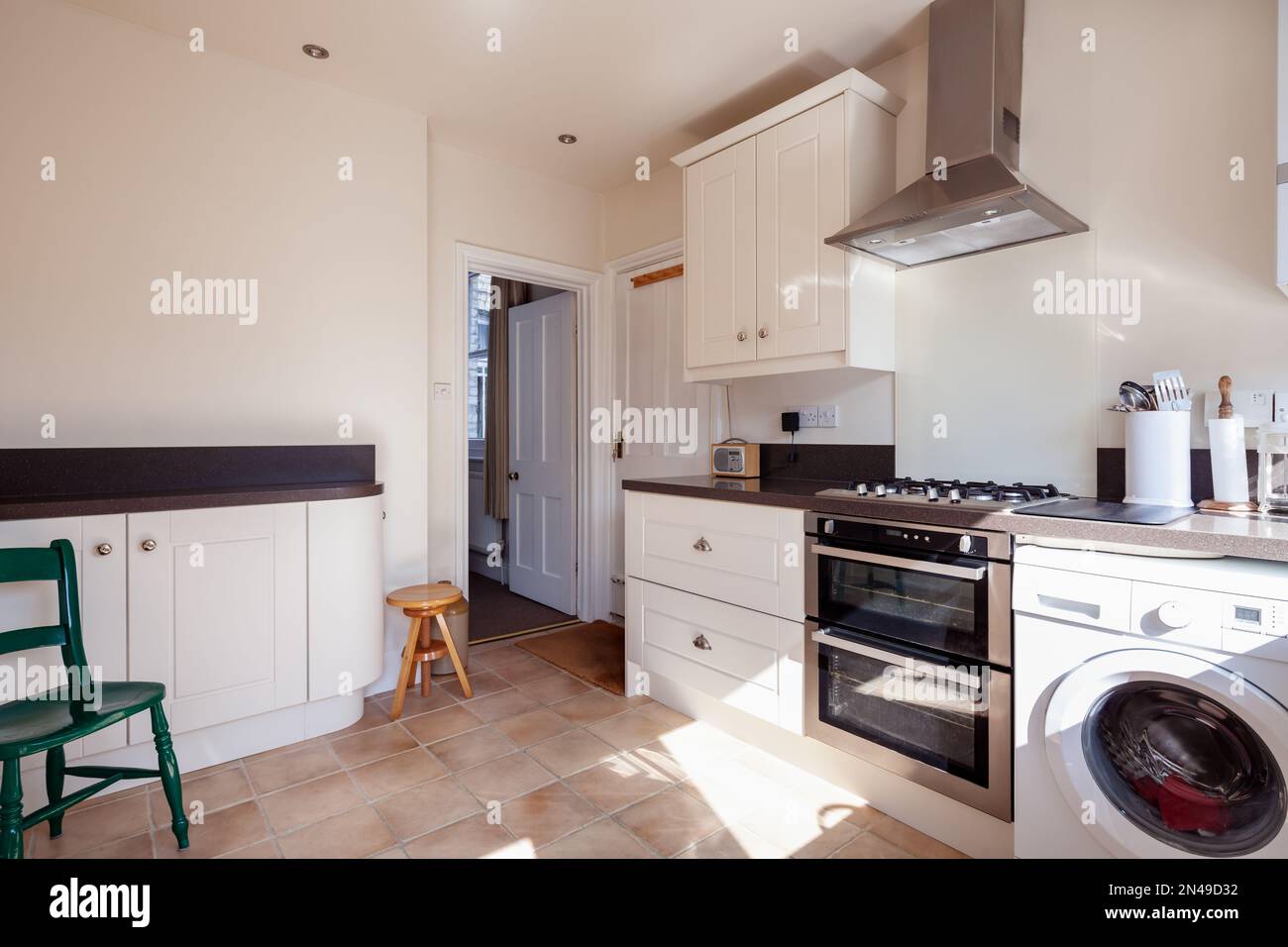 Traditional modern fitted kitchen with washing machine Stock Photo Alamy