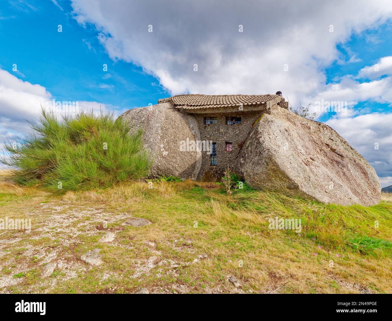 Boulder house or Casa do Penedo, a house built between huge rocks on ...