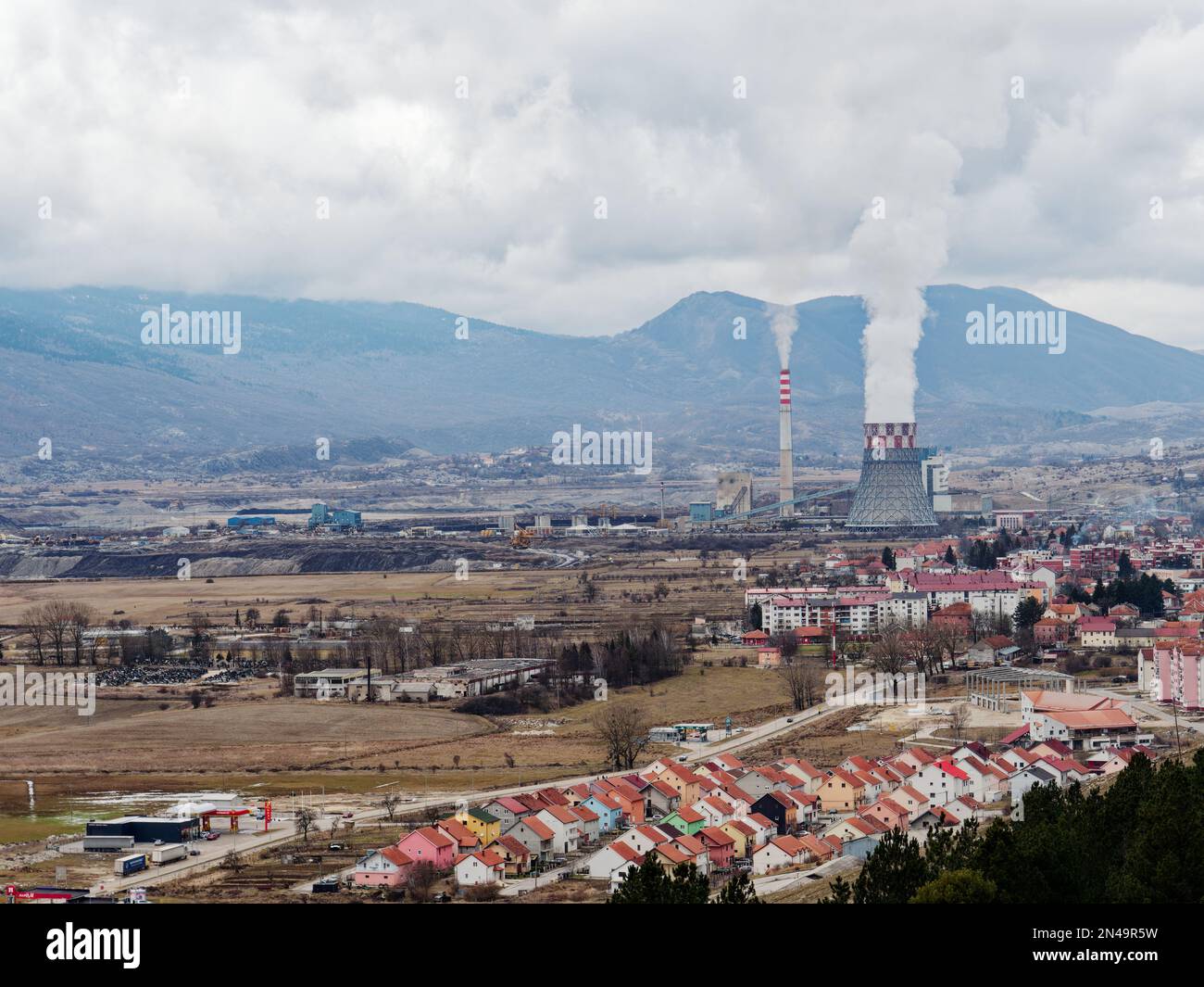Thermal power station expelling pollutants to the air. City with poor air quality due to thermal power plant. Burning fossil fuel. Toxic air. Stock Photo