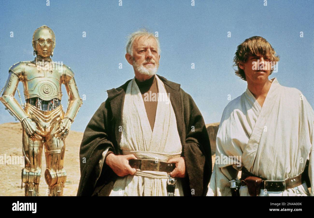 Star Wars  Star Wars Episode IV : A New Hope  Mark Hamill & Alec Guinness  C-3PO, Obi-Wan Kenobi,  Luke Skywalker Stock Photo