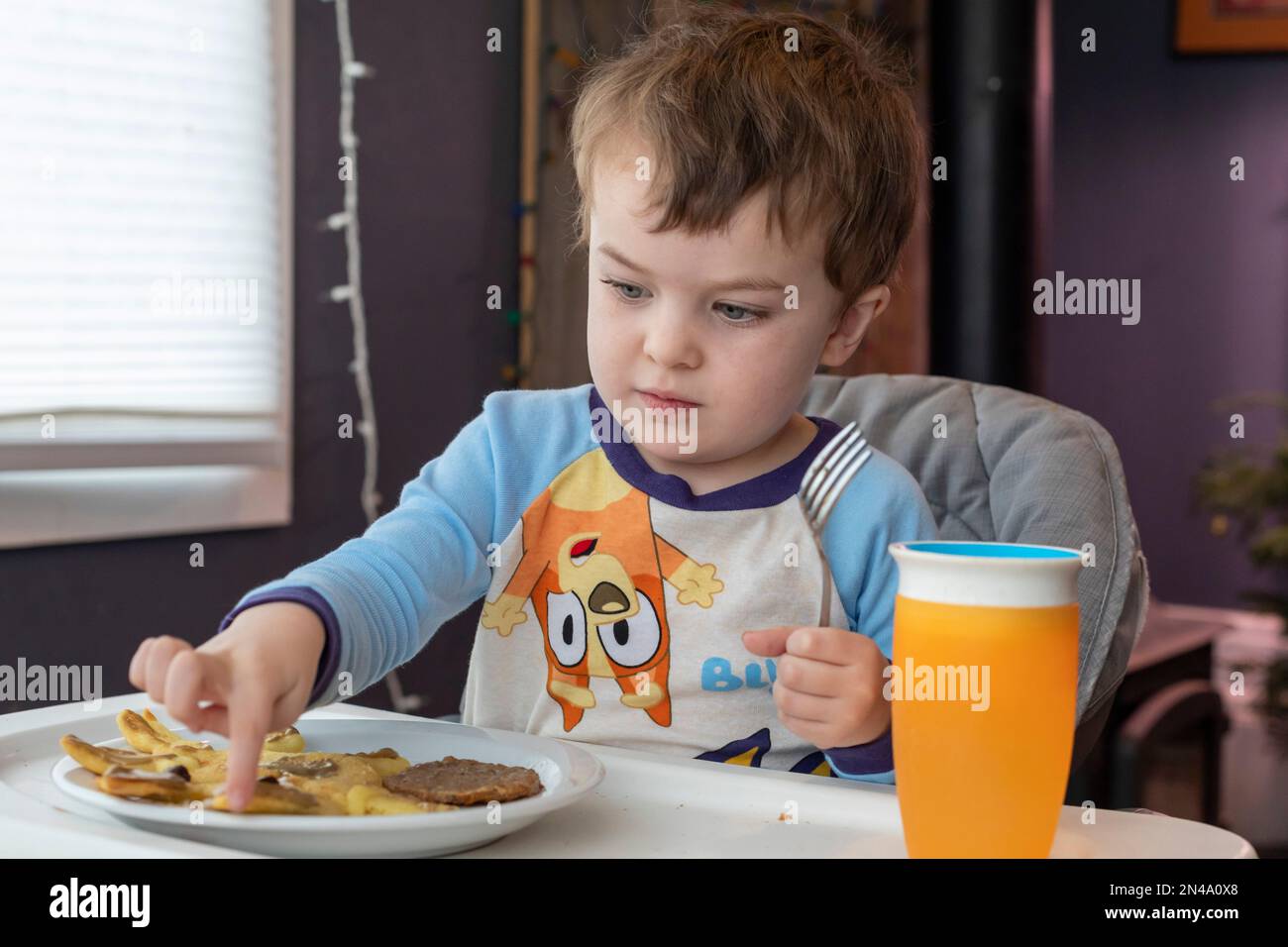 Denver, Colorado - Hendrix Hjermstad, 4, inspects his breakfast. Stock Photo