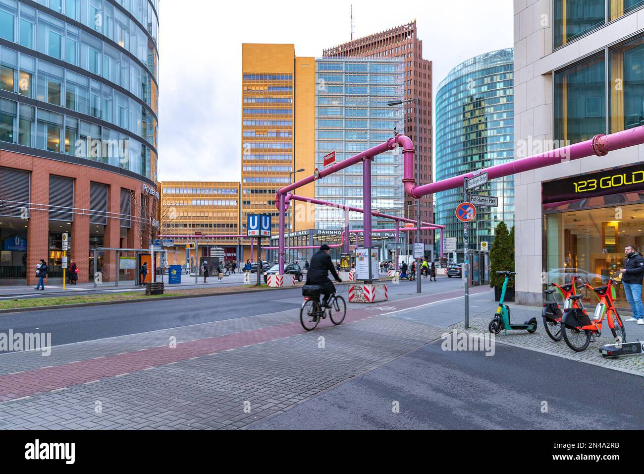 A bike path or a cycle path in Berlin, Germany. People and cyclists on the street in Berlin.Berlin architecture. S-Bahn sign. Stock Photo