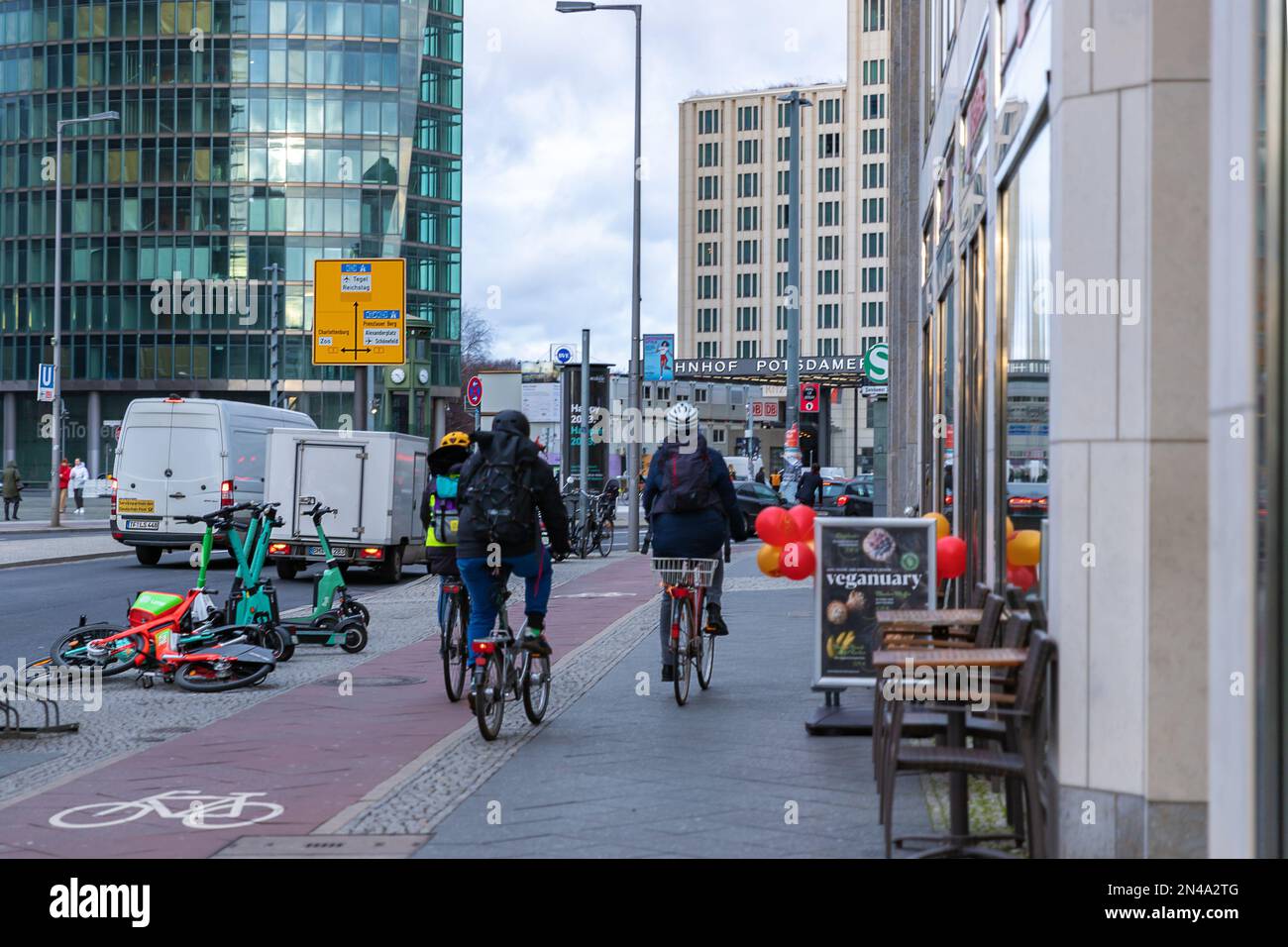 A bike path or a cycle path in Berlin, Germany. People and cyclists on