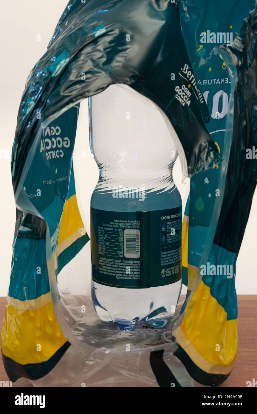 plastic bottle of water and torn plastic  polyethylene packaging Stock Photo