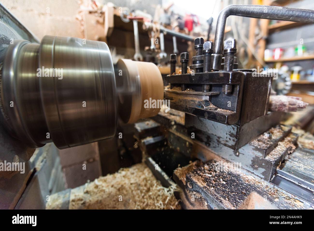 Timber Manipulation Close-up photo of a lathe working on wood. Mechanical processing of ...