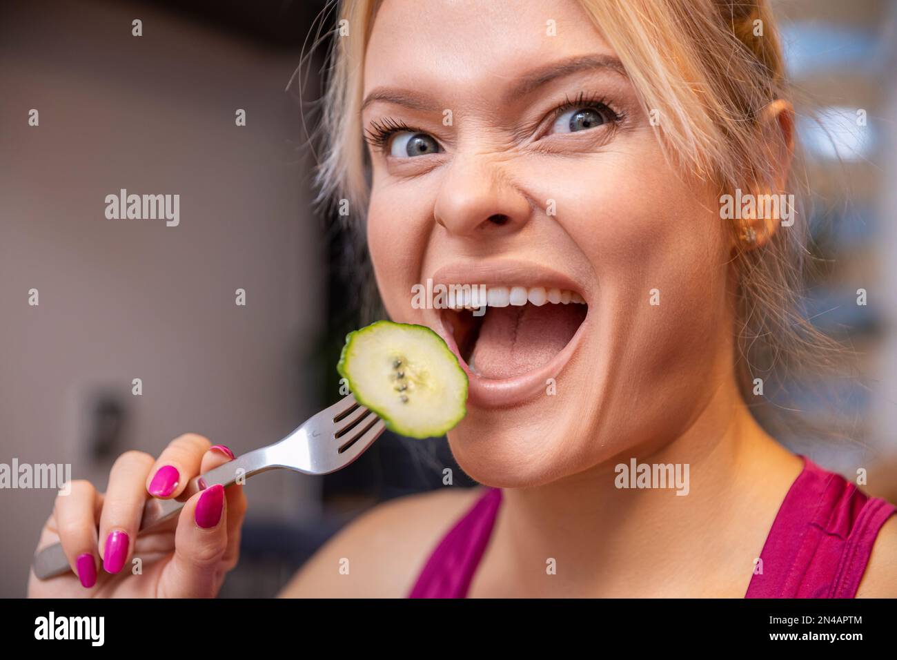 closeup on a woman's face making funny faces with her mouth open Stock
