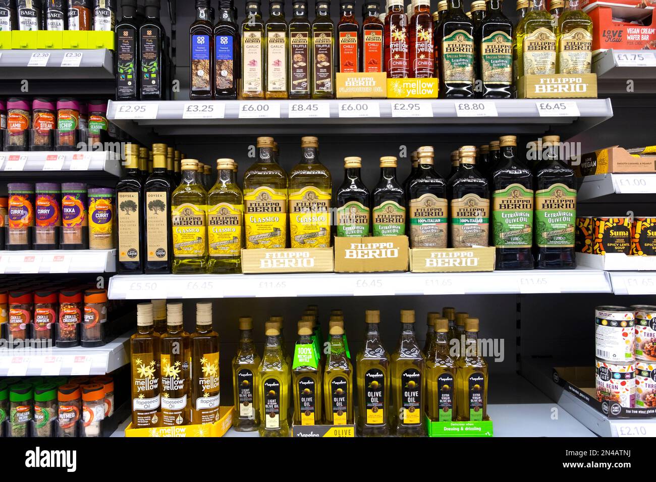 Row rows of glass bottles of Italian and Greek olive oil on British supermarket grocery store shelves shelf for sale in UK Great Britain  KATHY DEWITT Stock Photo