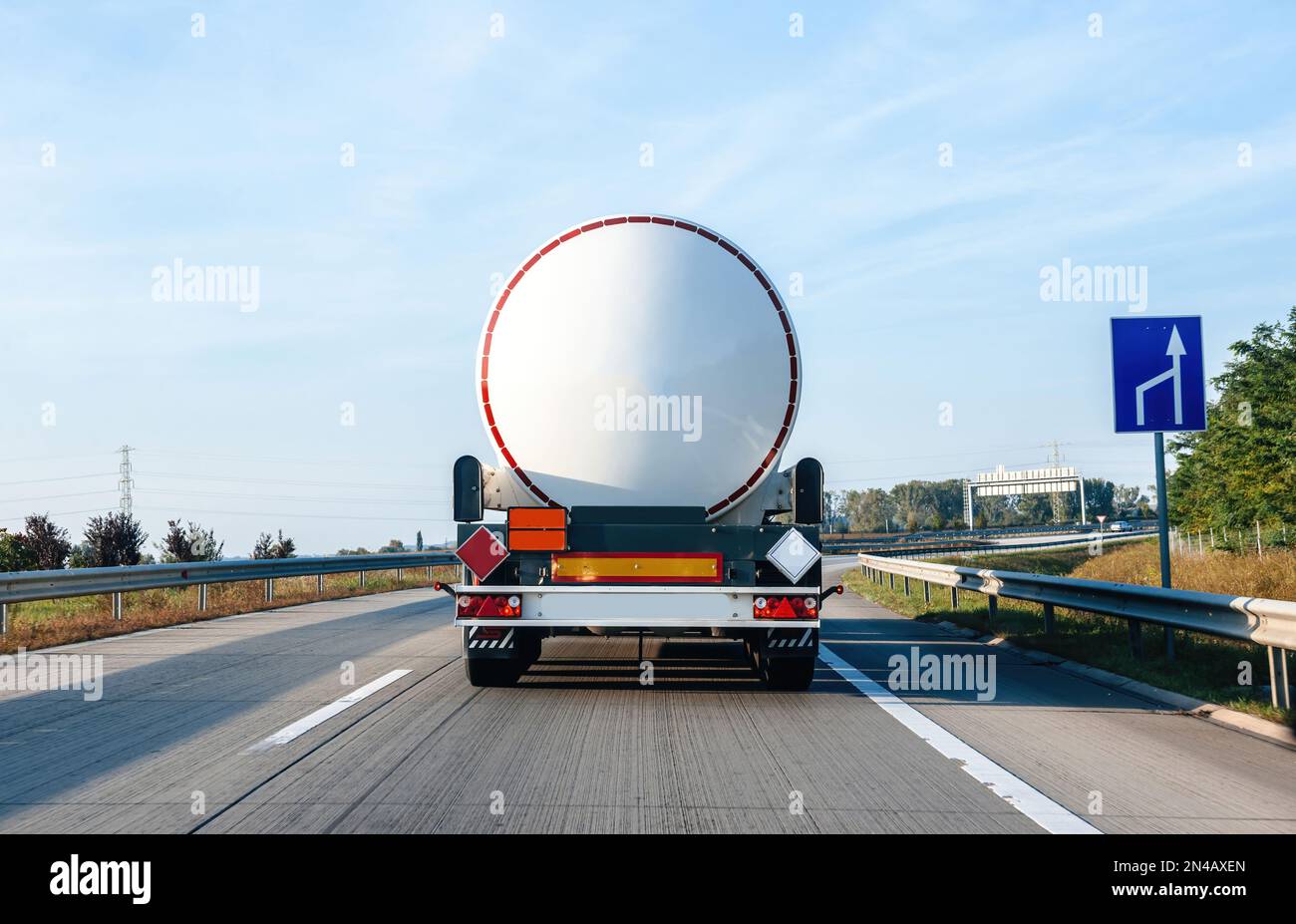 Rear view of white cistern truck driving fast on Hugarian highway woth ...