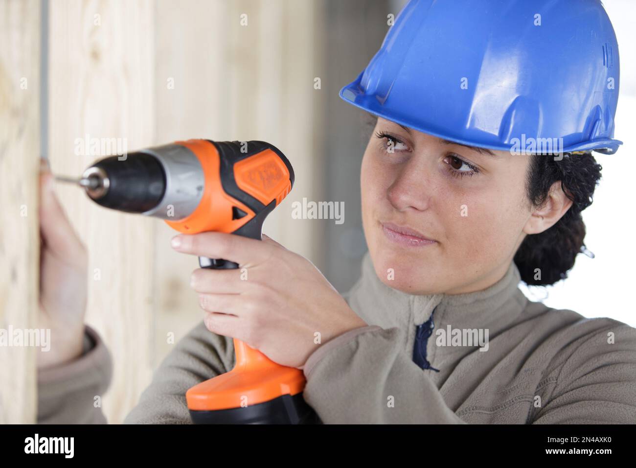 female construction worker using cordless drill Stock Photo