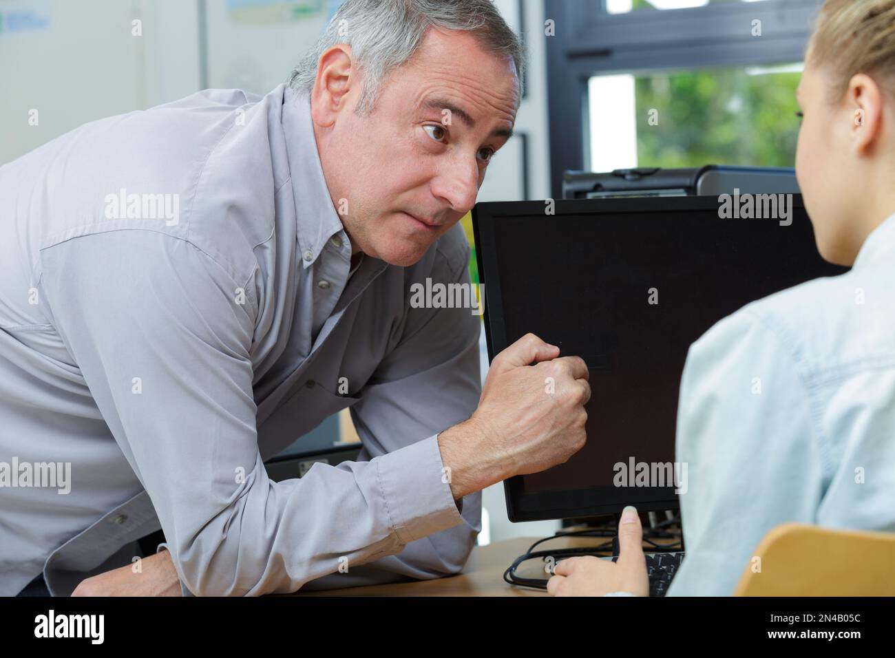 professor pointing at computer screen Stock Photo - Alamy