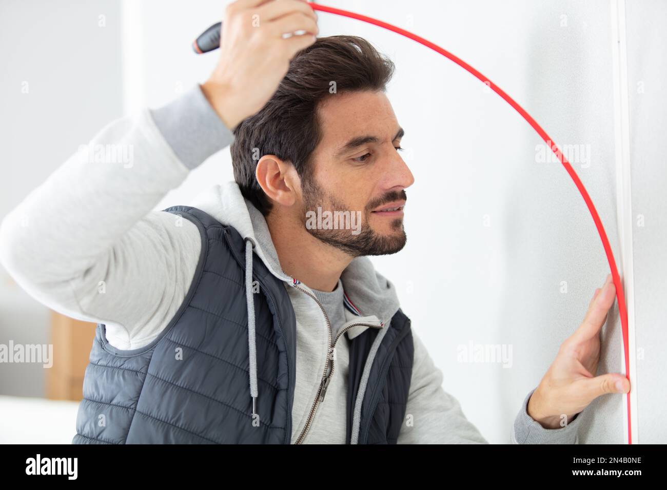 service man installing window with measure tape Stock Photo