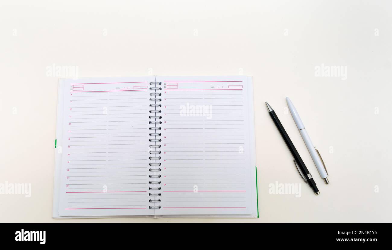 agenda on white background with pen and pencil Stock Photo