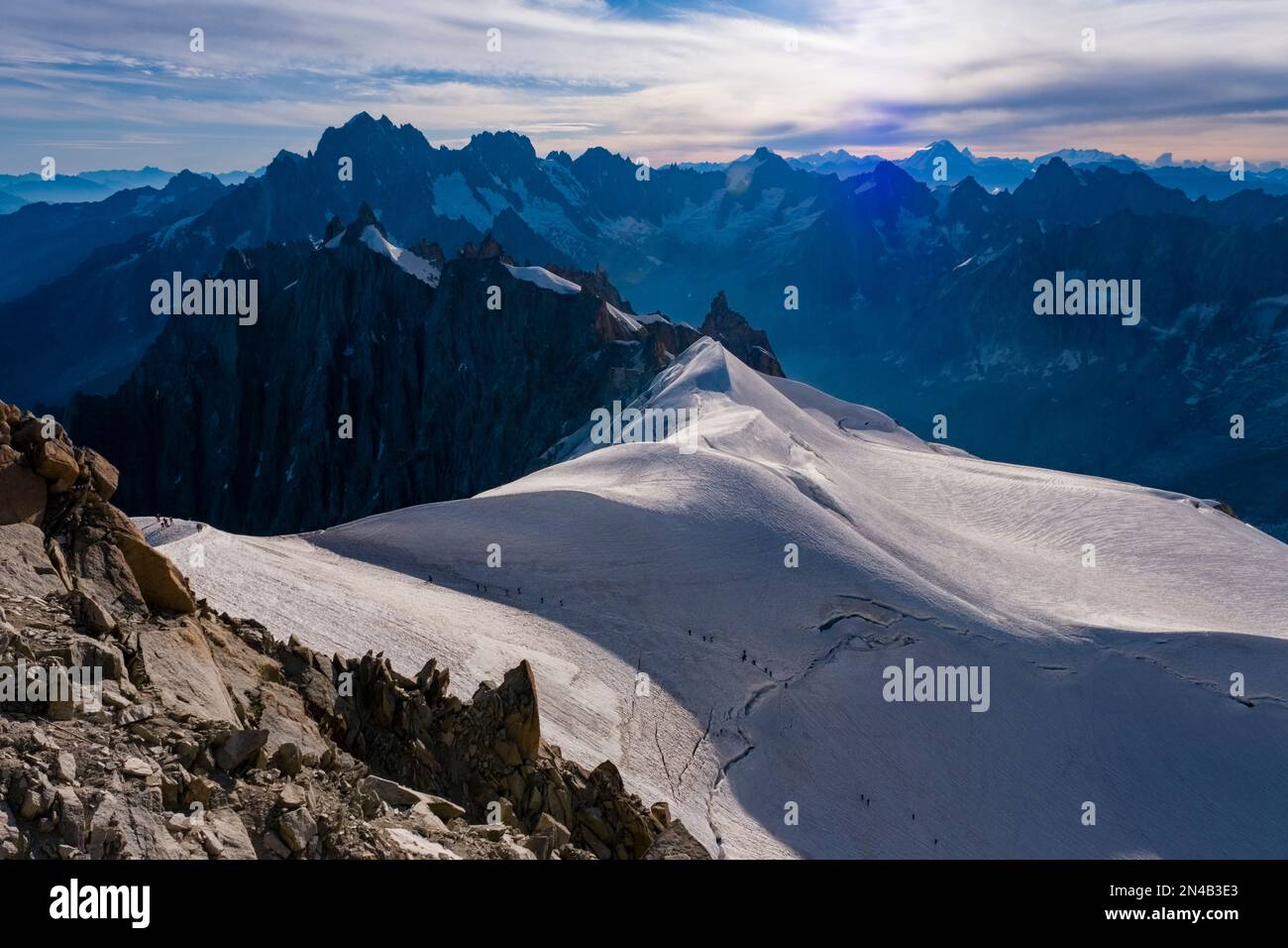 View of the upper part of the Géant Glacier and the eastern Mont Blanc massif, with Aiguille Verte standing out, alpinists crossing the ice. Stock Photo