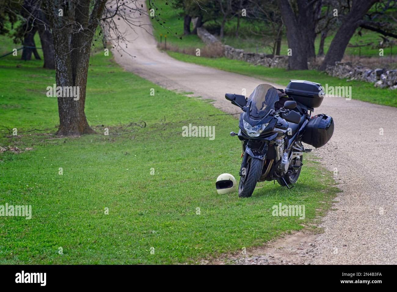 Touring motorcycle with panniers parked on a rural Texas Hill country