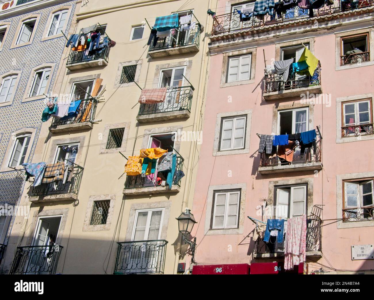 A wall of balconies with clotheslines and laundry air drying in Lisbon, Portugal Stock Photo