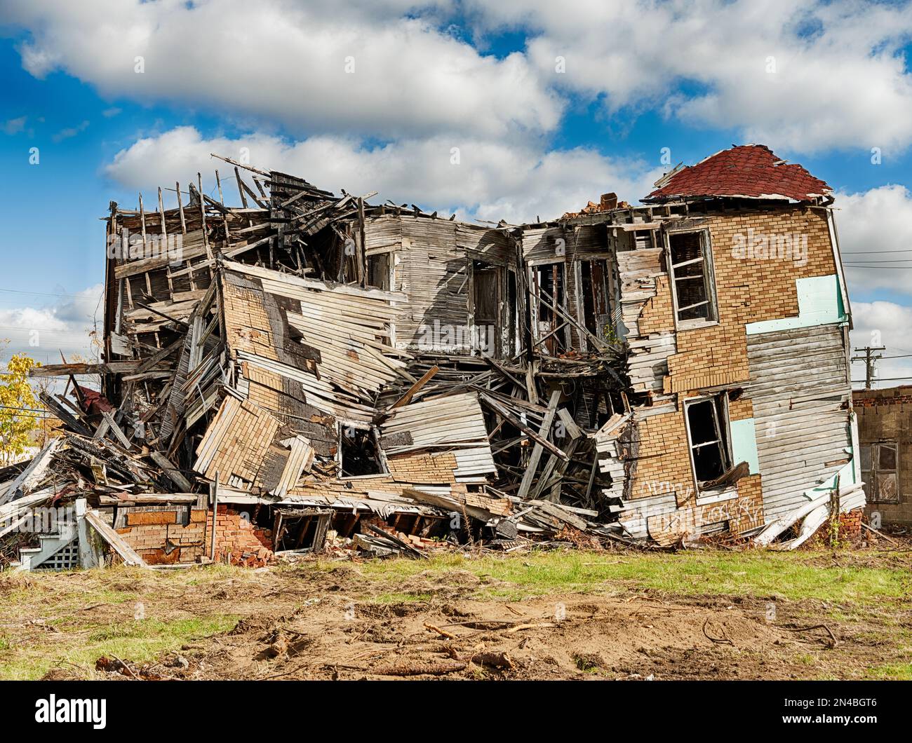 A partially demolished house is being torn down to make way for a new