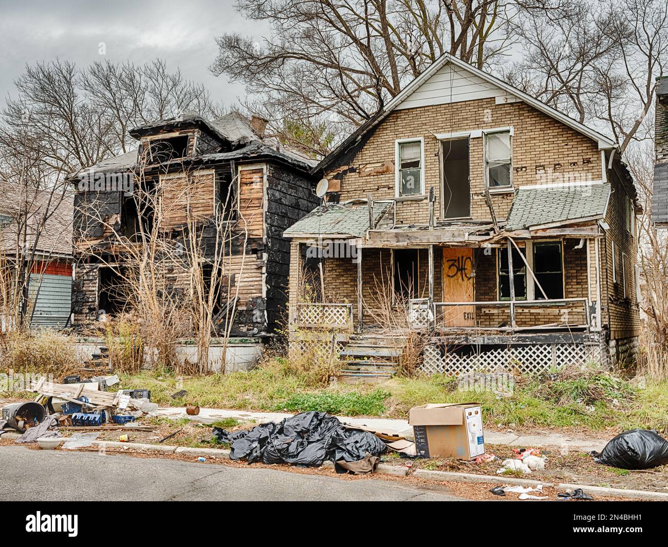 Two houses are abandoned and partially burned in Highland Park near