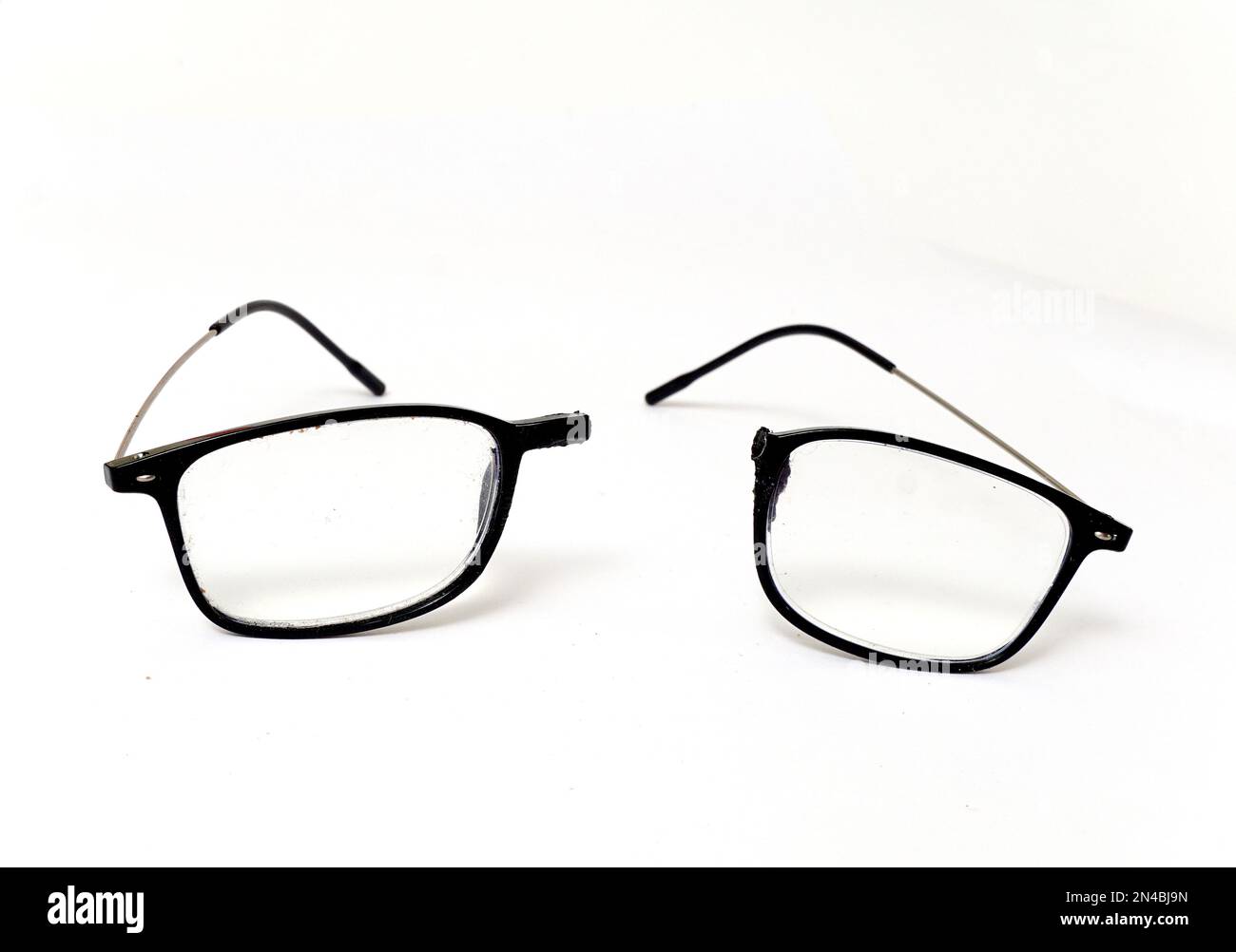 Broken reading glasses on white background Stock Photo Alamy