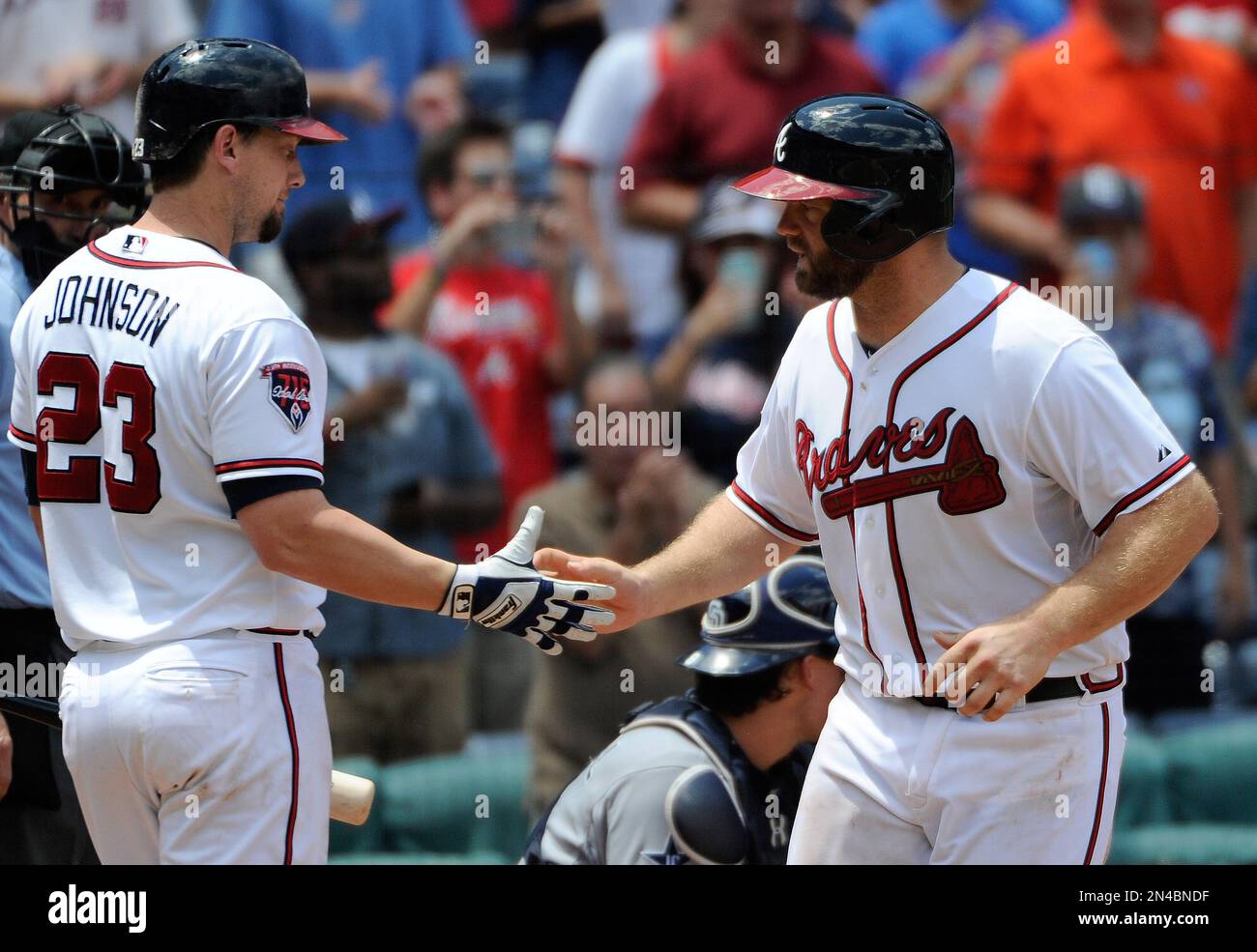 Atlanta Braves' Evan Gattis, right, is congratulated by Chris Johnson after  his solo home run against the San Diego Padres during the seventh inning of  a baseball game Monday, July 28, 2014