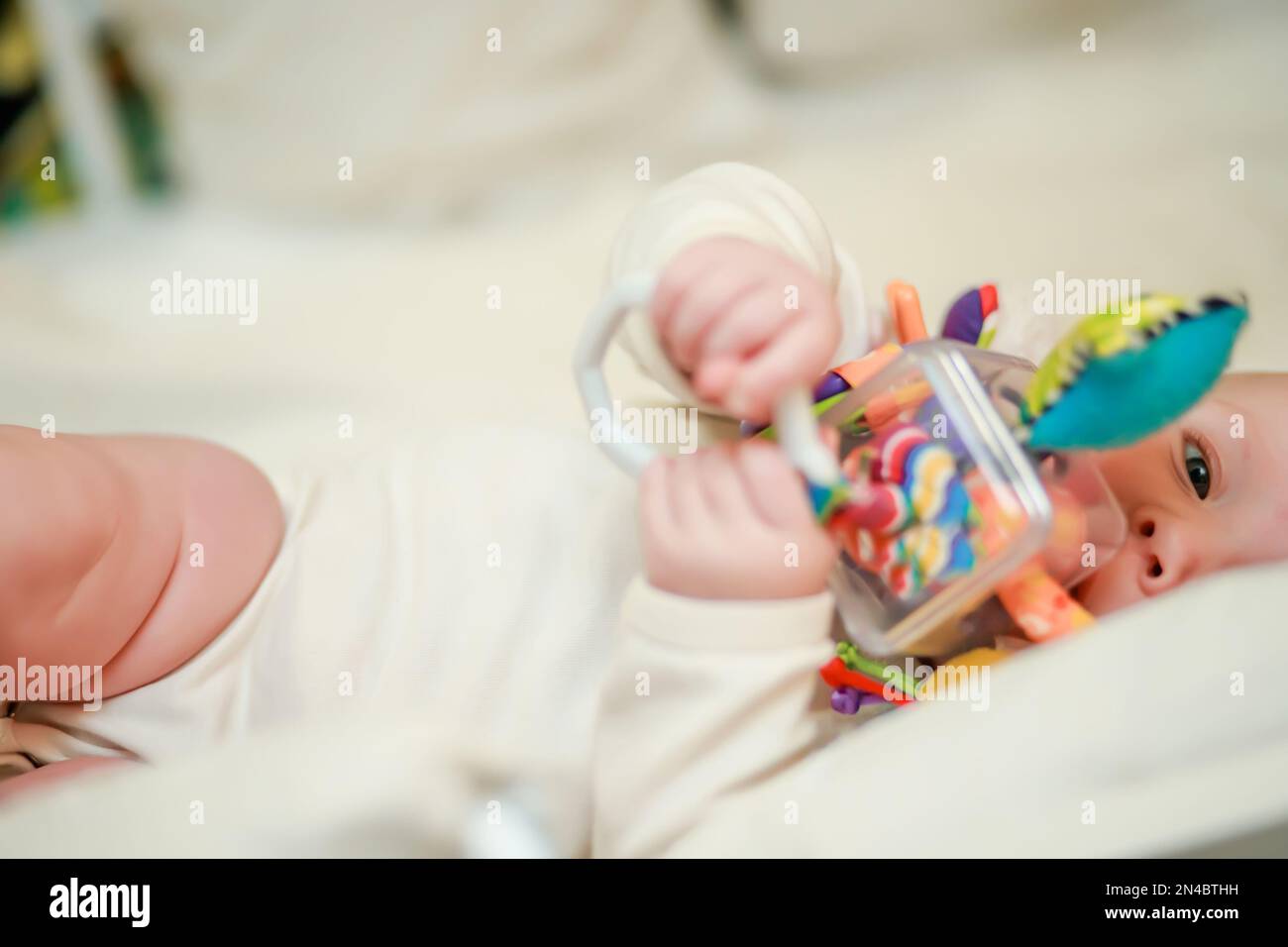 Baby playing rattle in kindergarten hi-res stock photography and images ...