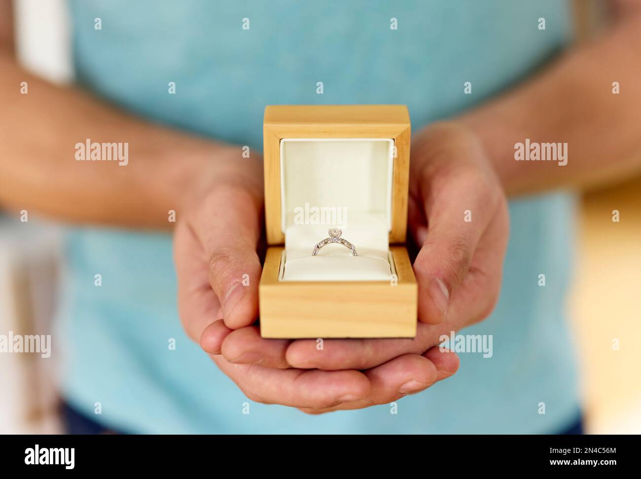 Man holding and presenting an open boxed engagement ring Stock Photo