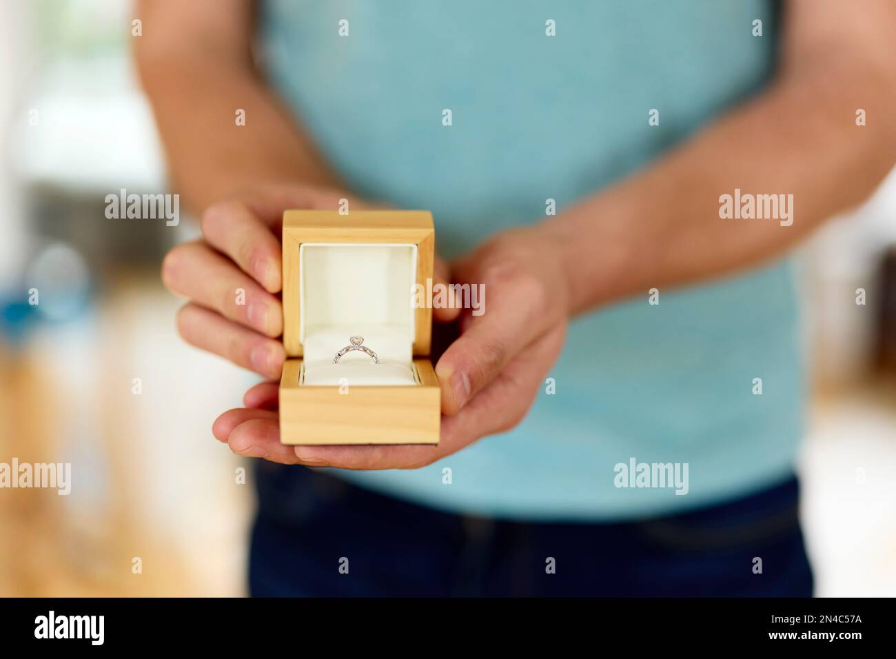 Man holding and presenting an open boxed engagement ring Stock Photo