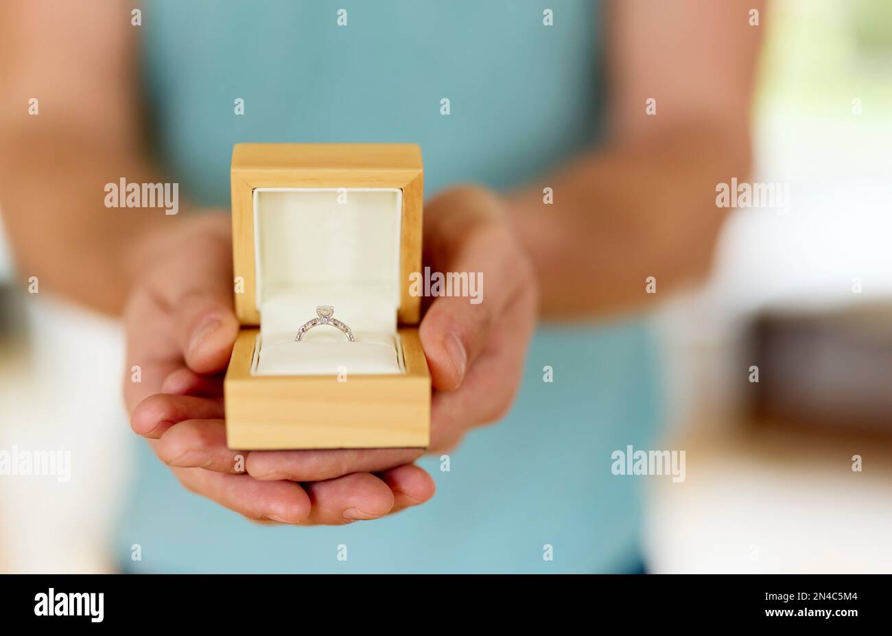 Man holding and presenting an open boxed engagement ring Stock Photo