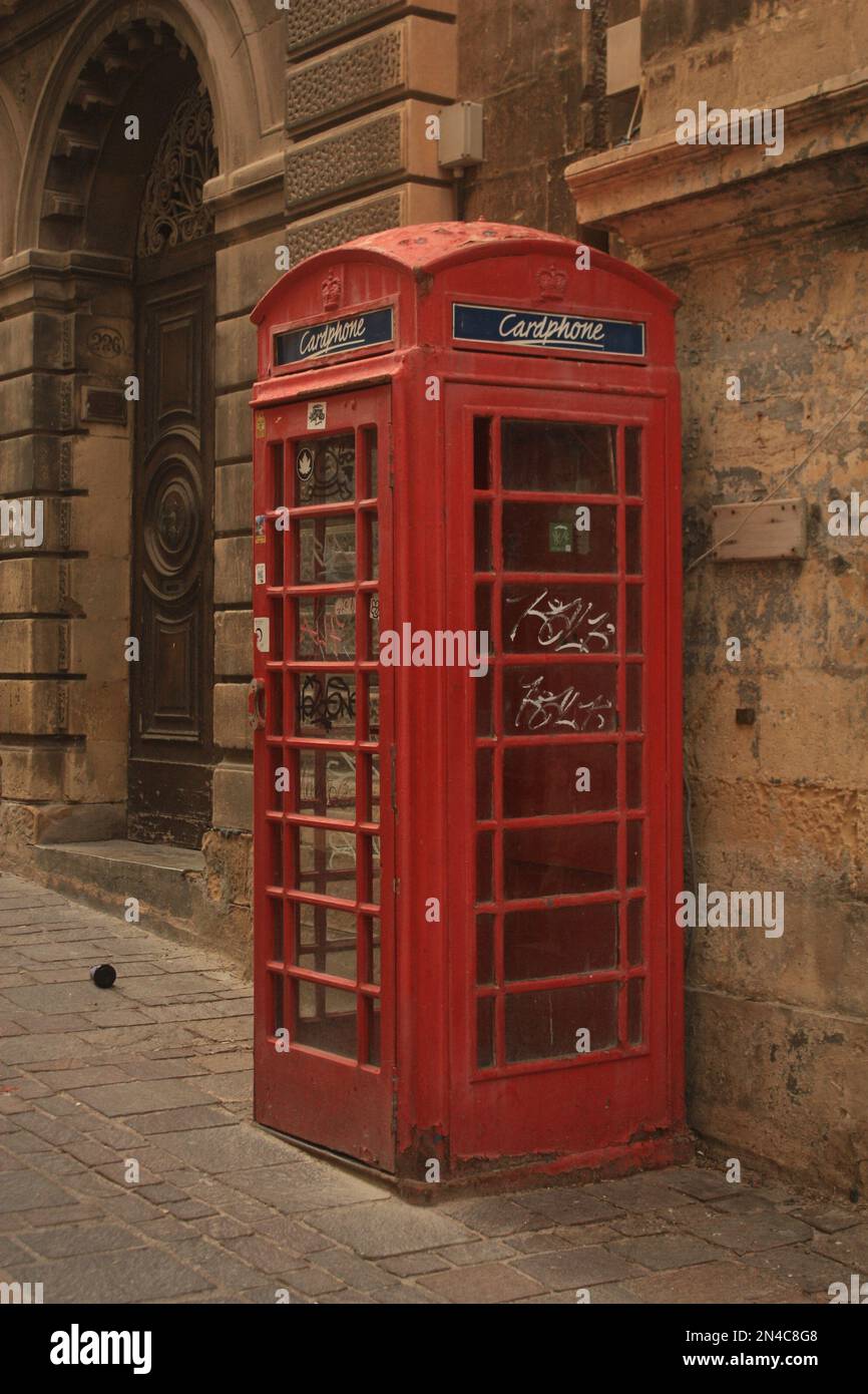 Red, English Phonebooth with grafiti on it, located on the island of ...