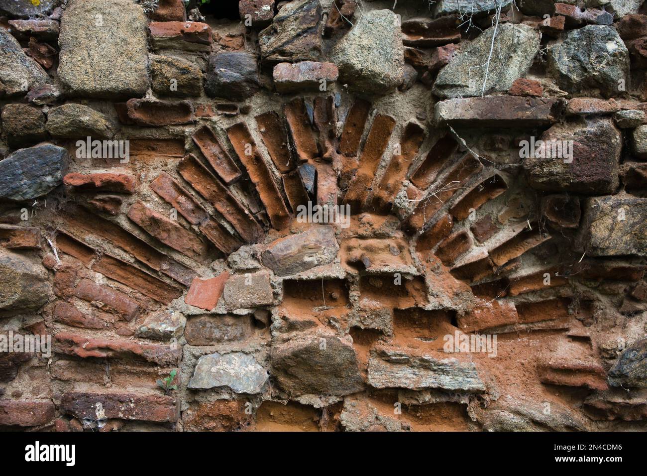 Texture of an old brick wall with an arched structure. Stock Photo