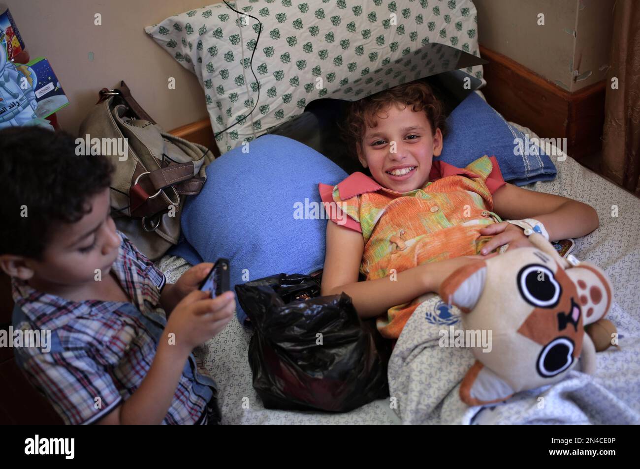 In this Thursday, July 24, 2014 photo, Nour alAreir , 10, waits for