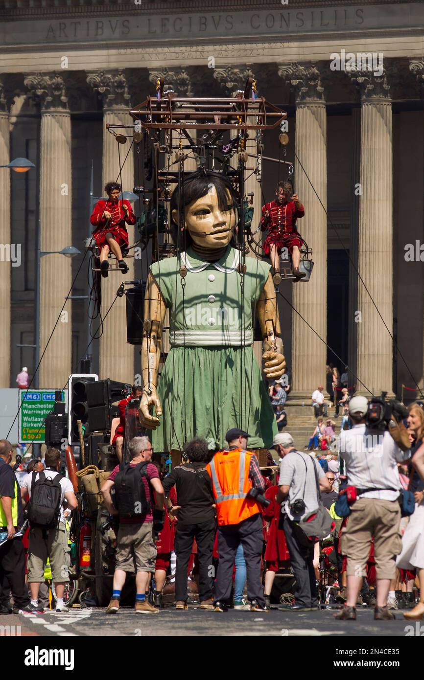 A giant of a girl is steered through the centre of Liverpool