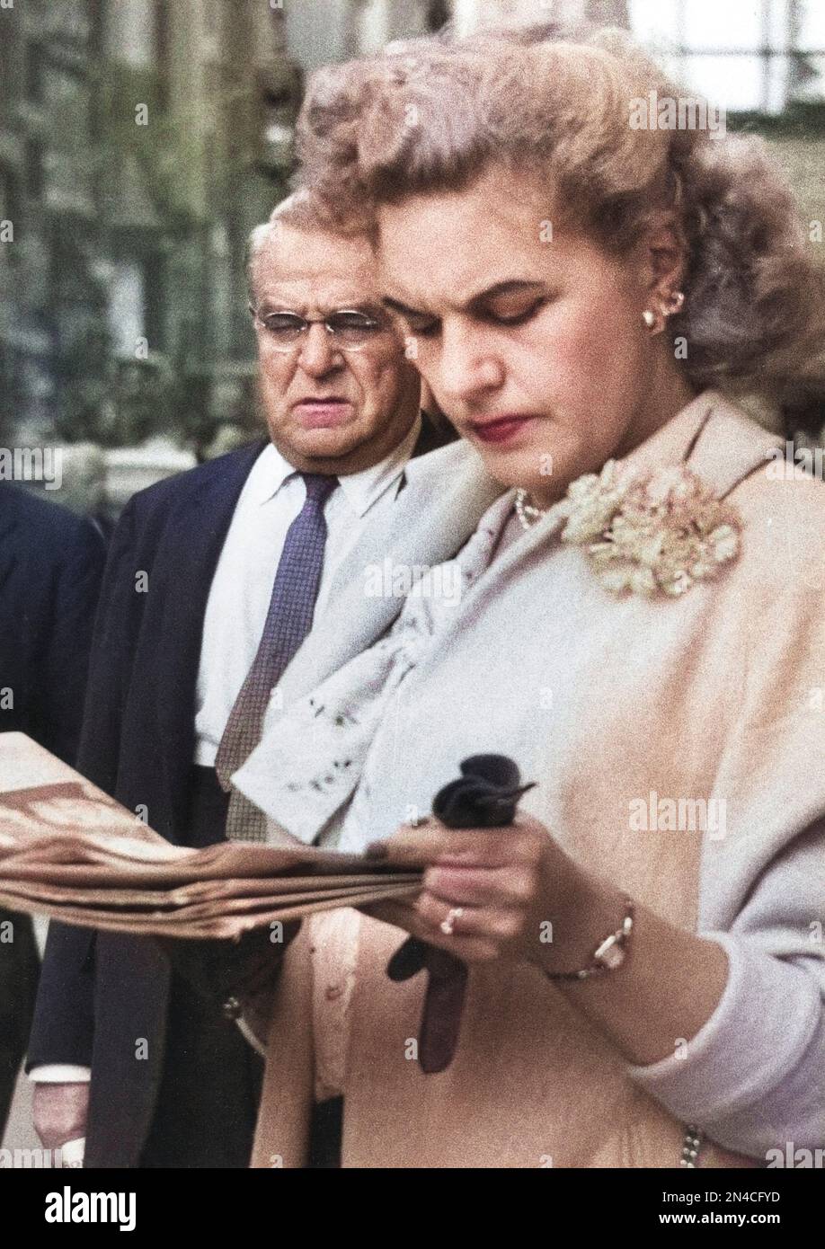 Half-Length Portrait of Woman reading Newspaper on Sidewalk, New York City, New York, USA, Angelo Rizzuto, Anthony Angel Collection, June 1958 Stock Photo