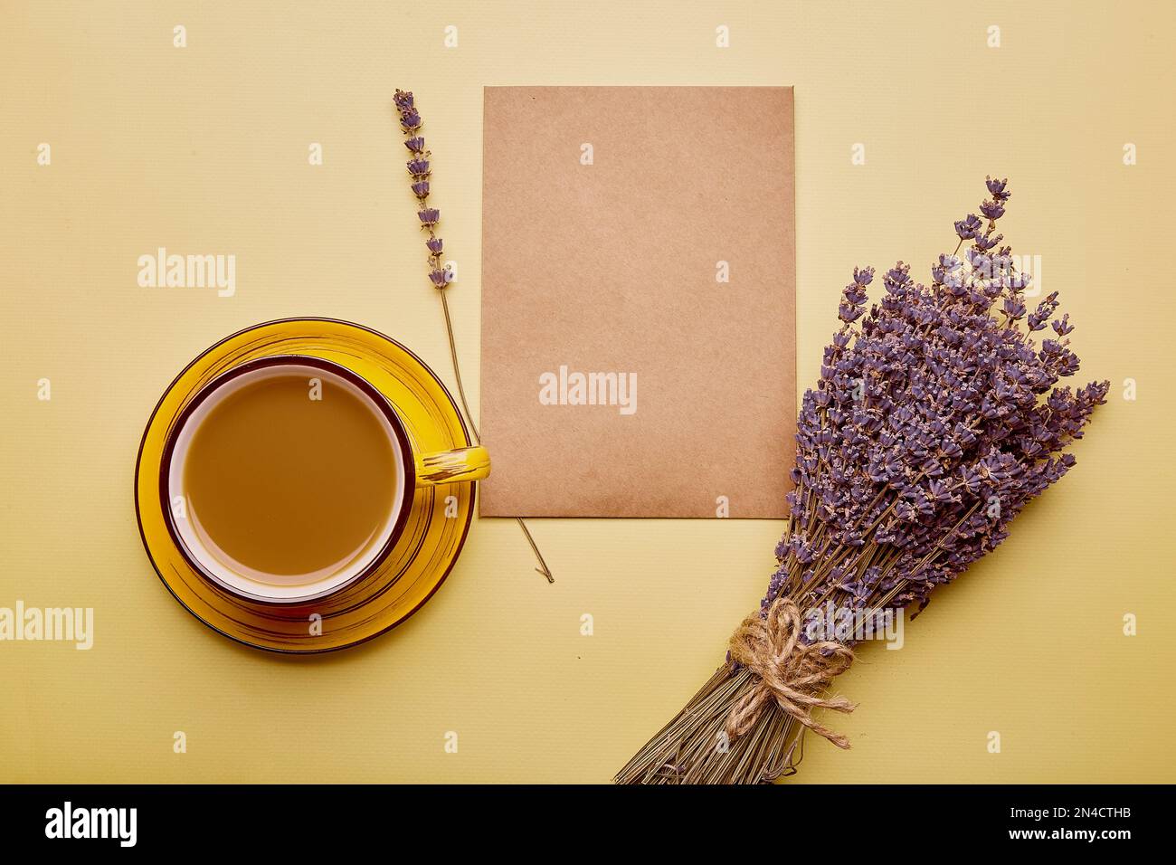 Mock up of envelope, crafting card with cup of coffee and lavender. Aesthetics flat lay Stock Photo