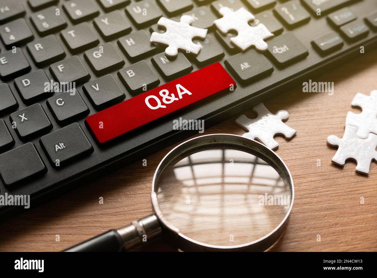 Magnifying glass, jigsaw puzzle and computer keyboard with red button
