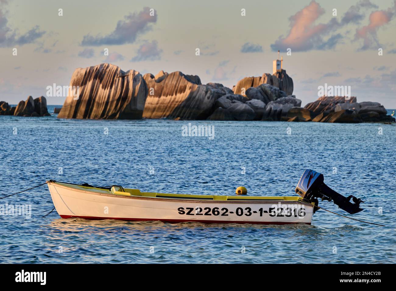 boat and rocks on La Digue, Seychelles Stock Photo